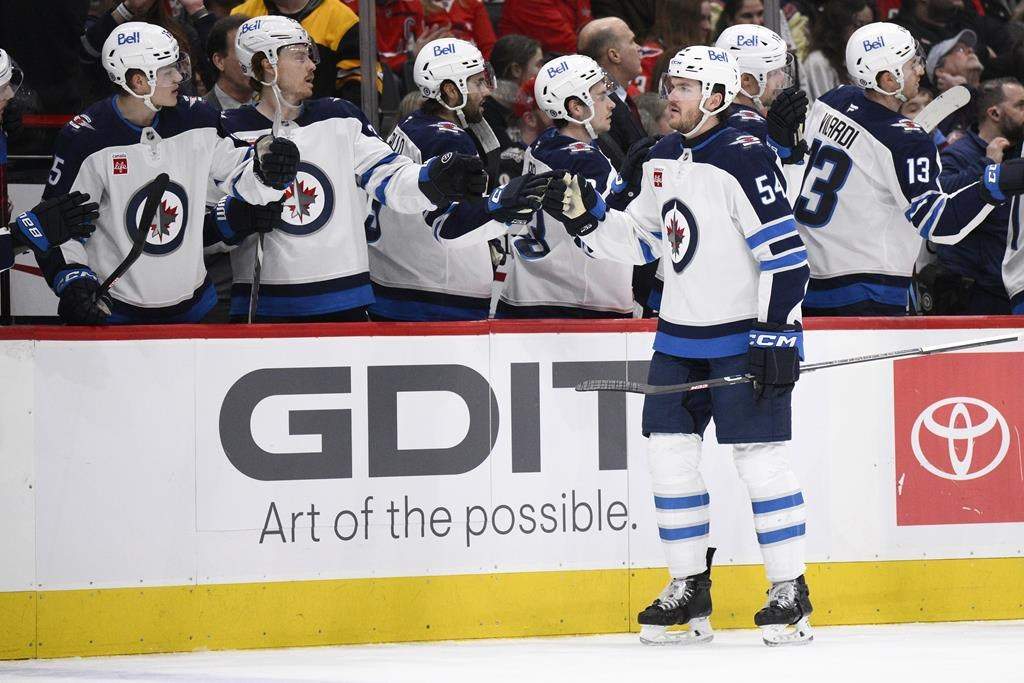 Winnipeg Jets defenseman Dylan Samberg (54) celebrates his goal during the first period of an NHL hockey game against the Washington Capitals, Saturday, Feb. 1, 2025, in Washington.