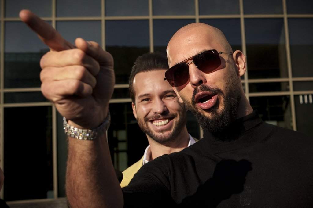 Andrew Tate gestures, next to his brother Tristan, outside the Bucharest Tribunal in Bucharest, Romania, Thursday, Jan. 9, 2025.