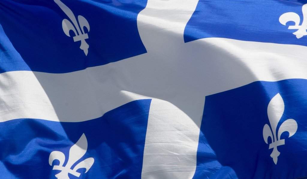 Quebec's labour tribunal has ordered a car dealership in south-central Quebec to rehire an employee it fired following a sexual assault conviction. Quebec's provincial flag flies in Ottawa on June 30, 2020. 