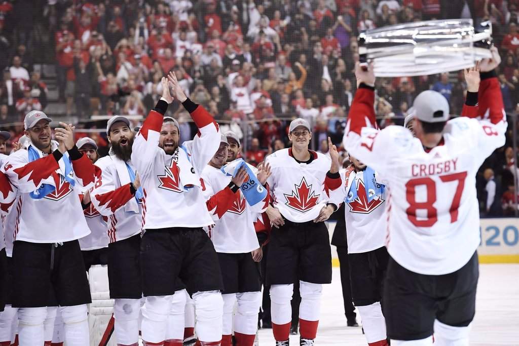 Team Canada's Sidney Crosby (87) hoists the trophy in front of teammates following his team's victory over Team Europe during the 2016 World Cup of Hockey.