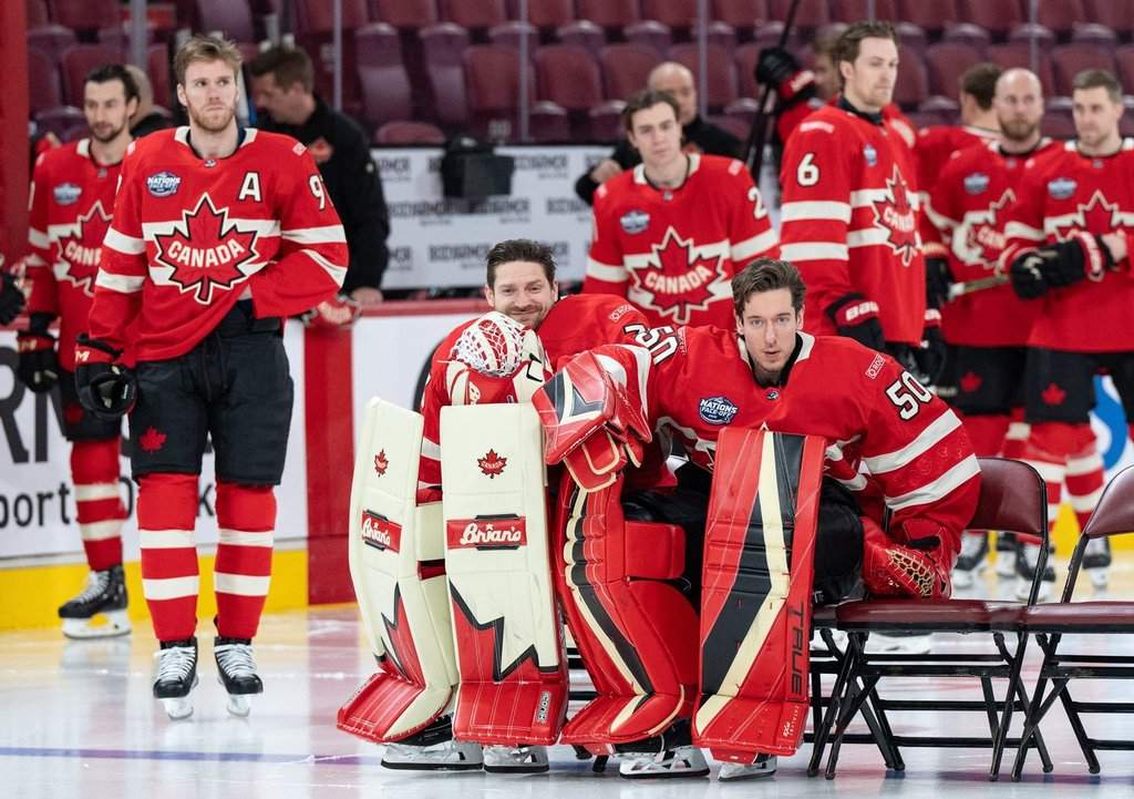 Canada goaltenders Adin Hill and Jordan Binnington prepare for the team photo prior to 4 Nations Face-Off hockey practice in Montreal, Tuesday, Feb. 11, 2025.