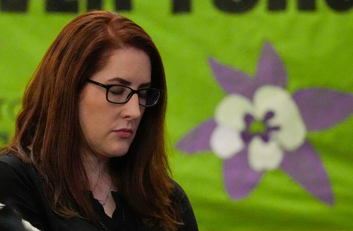 FILE - Columbine High School shooting survivor Anne Marie Hochhalter reacts during a vigil remembering the 25th anniversary of the mass shooting, April 19, 2024, in Denver.