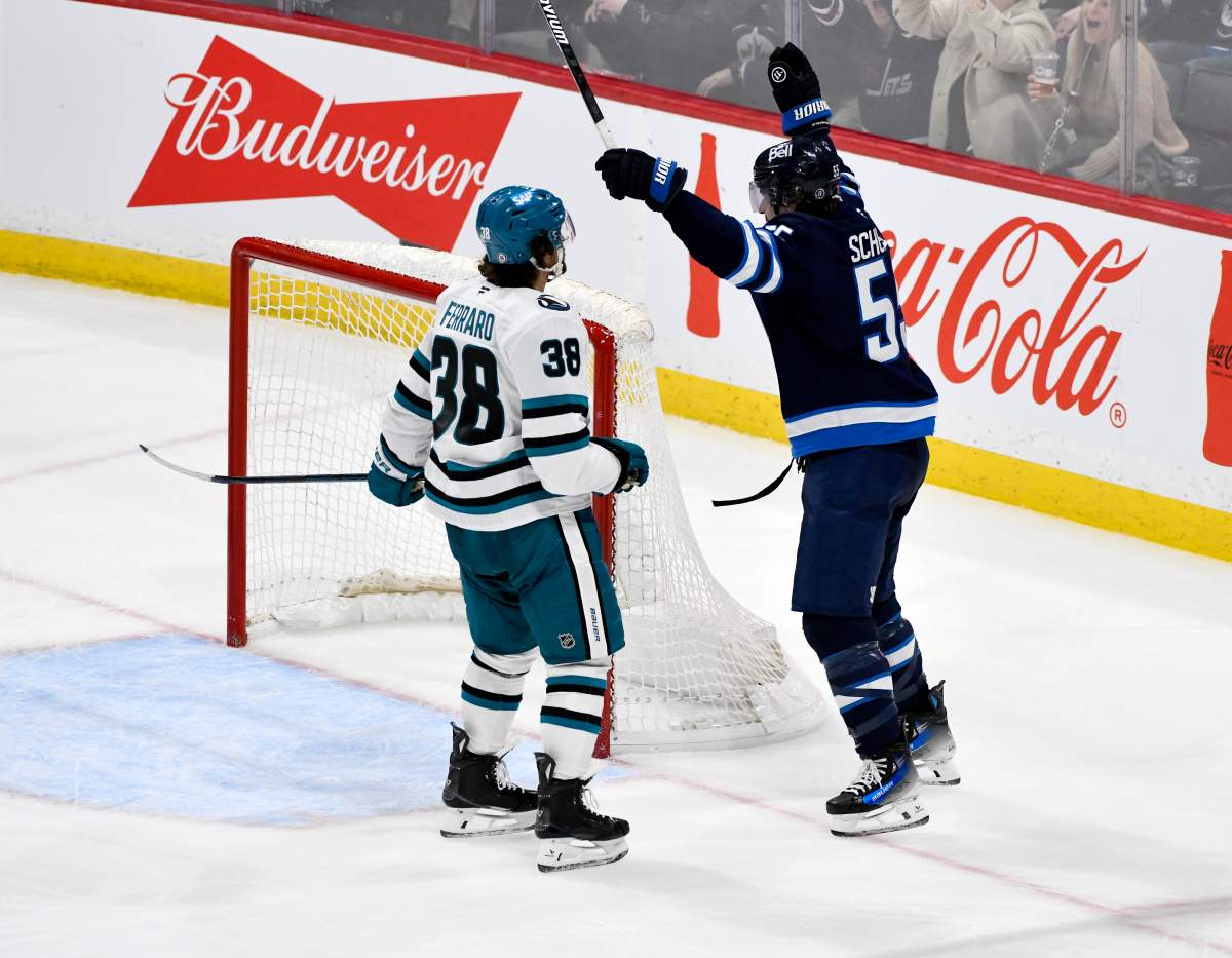 Winnipeg Jets' Mark Scheifele (55) celebrates his game-winning goal in overtime in front of San Jose Sharks' Mario Ferraro (38) during NHL hockey action in Winnipeg, Monday, Feb. 24, 2025. THE CANADIAN PRESS/Fred Greenslade.