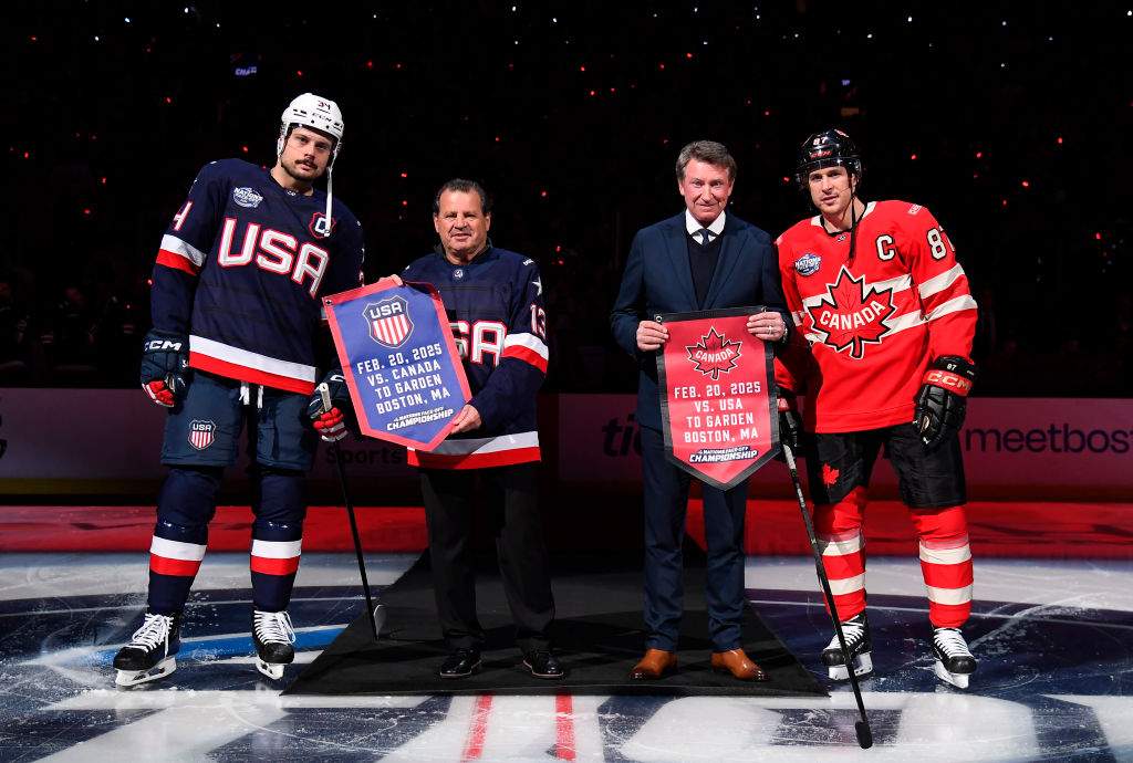 (L-R) Auston Matthews #34 of Team United States, honorary captains Mike Eruzione of Team United States and Wayne Gretzky of Team Canada and Sidney Crosby #87 of Team Canada pose for a photo at center ice during pre-game ceremonies before the 4 Nations Face-Off Championship game between Team Canada and Team United States at TD Garden on February 20, 2025 in Boston, Massachusetts.