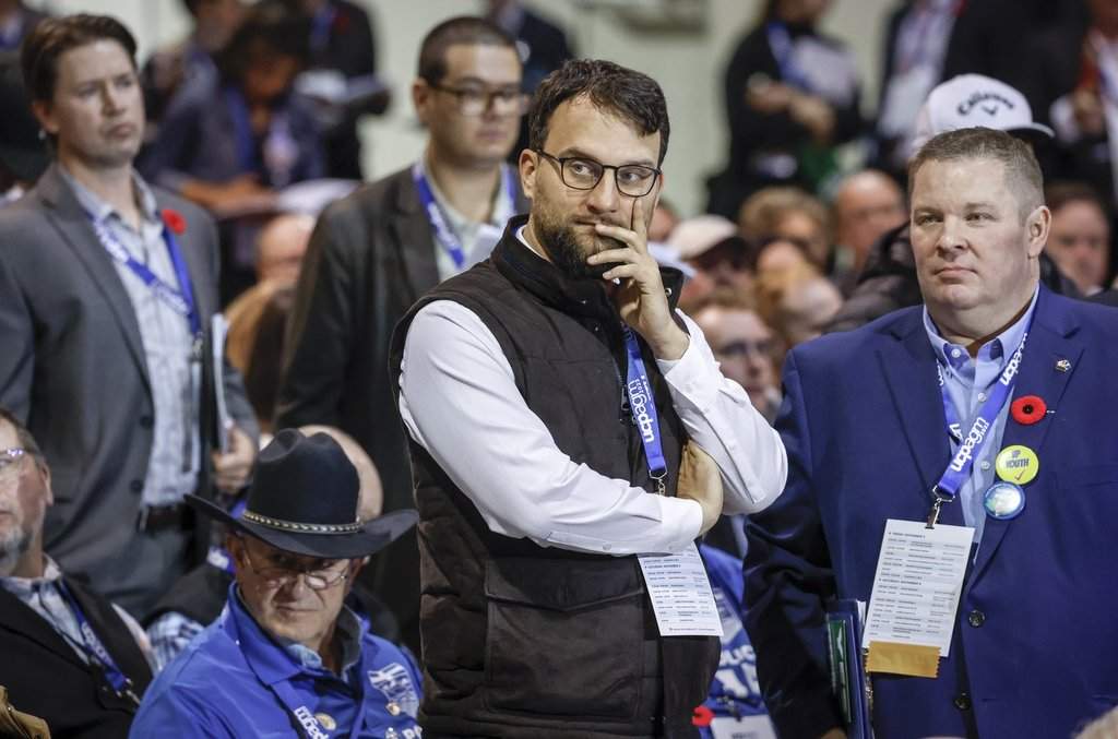 David Parker, centre, founder of Take Back Alberta, looks on as delegates debate resolutions at the United Conservative Party annual general meeting in Calgary, Alta., on Sat., Nov. 4, 2023. THE CANADIAN PRESS/Jeff McIntosh.