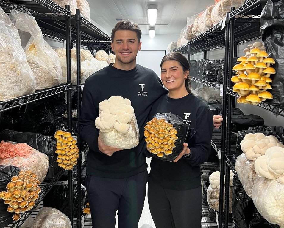 Cavalry FC midfielder Charlie Trafford and his sister Sya Trafford, co-founders of Trafford Farms show off some of the mushrooms they produce in this handout image.