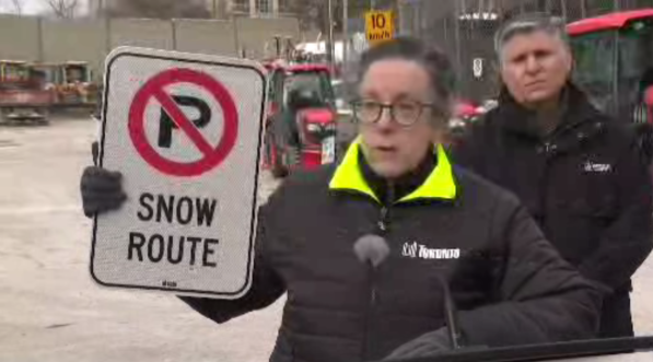 Barbara Gray, City of Toronto’s general manager for Transportation Services holds up a snow route sign on Feb. 12, 2025.