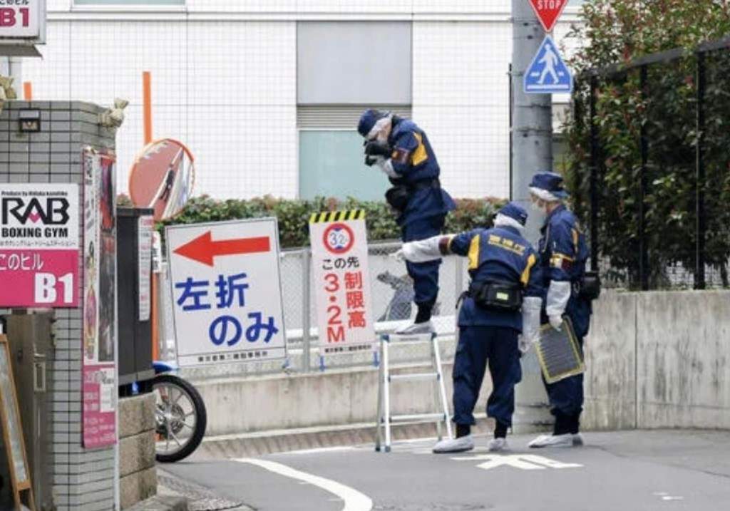Japanese police investigators work near the scene of a stabbing of a woman in the Shinjuku district of Tokyo, Tuesday, March 11, 2025.