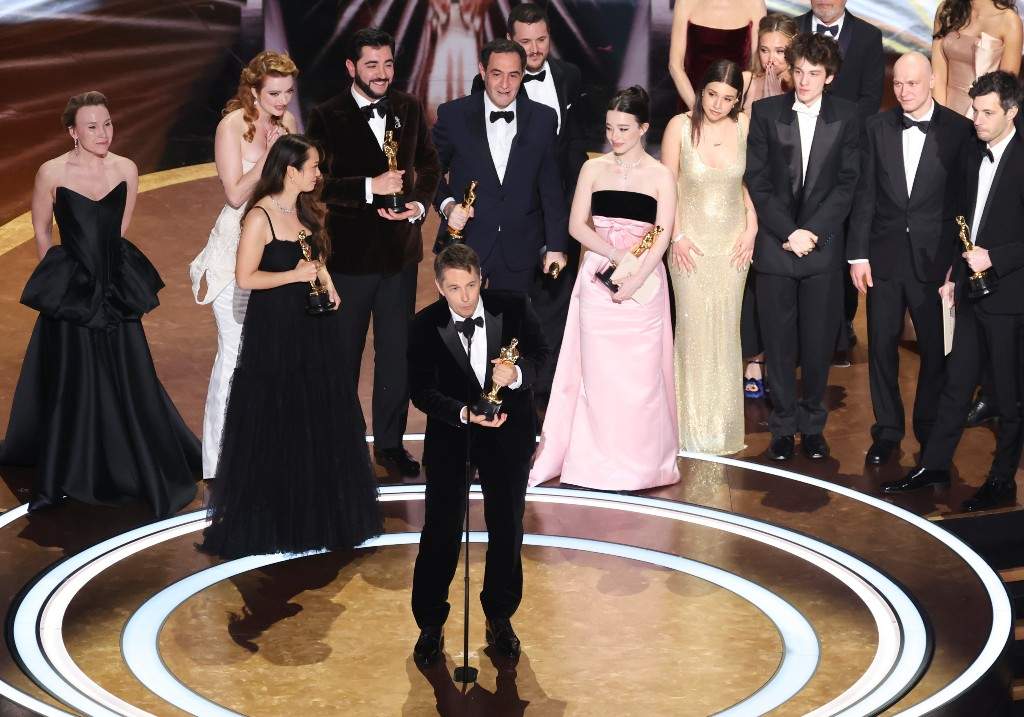 US filmmaker Sean Baker accepts the award for Best Picture for "Anora", flanked by US actress Mikey Madison, Armenian-US actor Karren Karagulian, Armenian actor Vache Tovmasyan, and Canadian producer Samantha Quan, onstage during the 97th Annual Academy Awards at the Dolby Theatre in Hollywood, California on March 2, 2025.