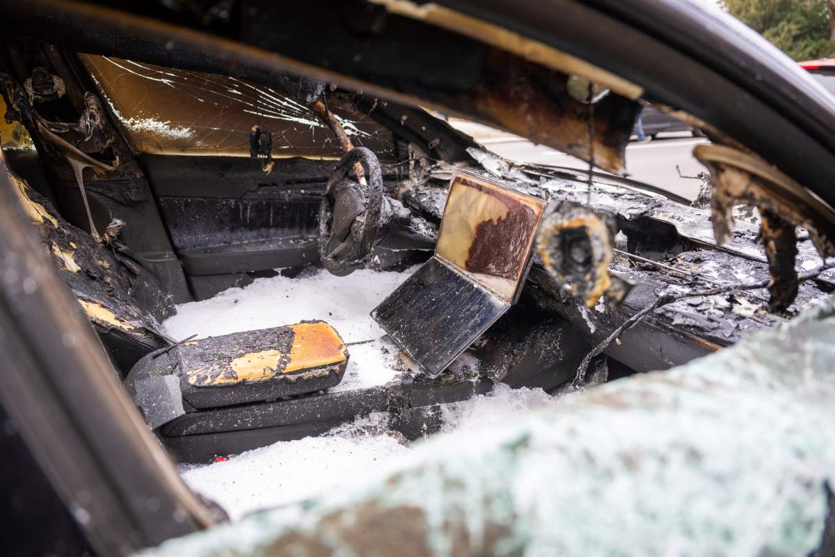 A burnt-out Tesla car stands in the Steglitz district of Berlin, Friday, March 14, 2025, as four Teslas are suspected to have been set on fire in Berlin.