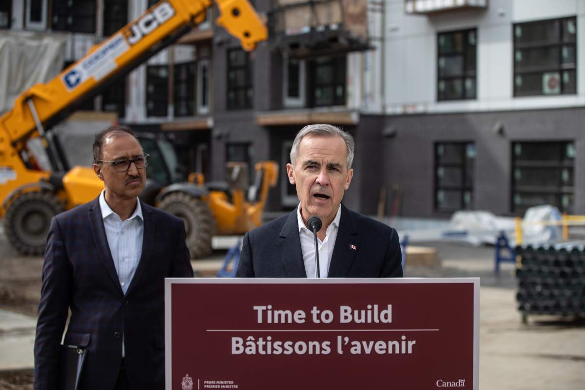 Prime Minister Mark Carney announces funding for houses as Edmonton Mayor Amarjeet Sohi listens during a visit to Edmonton, Thursday, March 20, 2025.