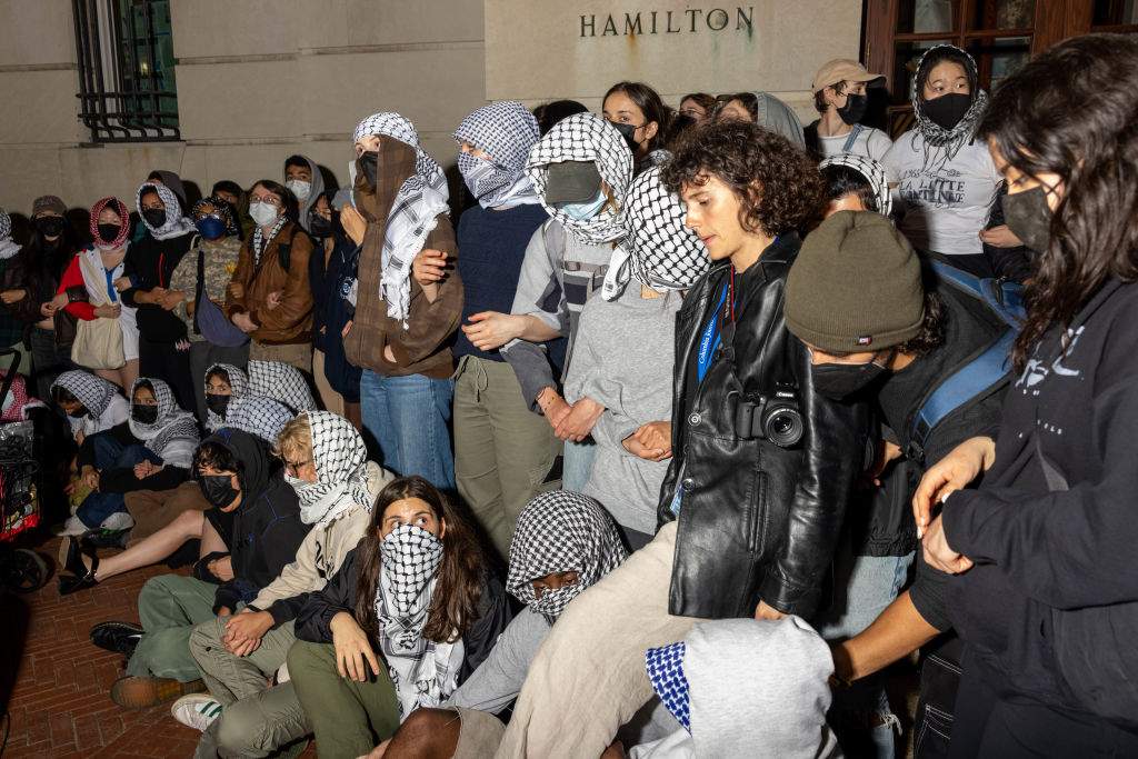 Students/demonstrators lock arms to guard potential authorities against reaching fellow protestors who barricaded themselves inside Hamilton Hall, an academic building which has been occupied in past student movements,, and name it after a Palestinian child allegedly killed by the Israeli military on Tuesday, April 30, 2024 in New York City. Pro-Palestinian demonstrators marched around the "Gaza Solidarity Encampment" at Columbia University as a 2 P.M. deadline to clear the encampment given to students by the university passed. The students were given a suspension warning if they do not meet the deadline. Columbia students were the first to erect an encampment in support of Palestine, with students demanding that the school divest from Israel amid the Israel-Hamas war, where more than 34,000 Palestinians have been killed in the Gaza Strip. (Photo by Alex Kent/Getty Images)