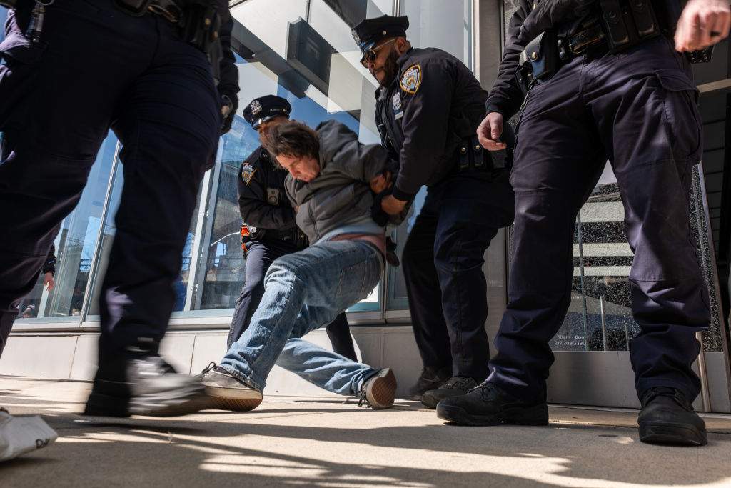 Protesters are arrested as they gather outside of a Manhattan Tesla dealership to demonstrate against Tesla CEO Elon Musk on March 08, 2025, in New York City. Working as a "special government employee" of the Trump administration, Musk and his Department of Government Efficiency (DOGE) have recently made dramatic cuts across federal agencies. Tesla profits have been falling, and in its longest losing streak in its 15 years as a public company, profits were down Friday at $270.48. (Photo by Spencer Platt/Getty Images)