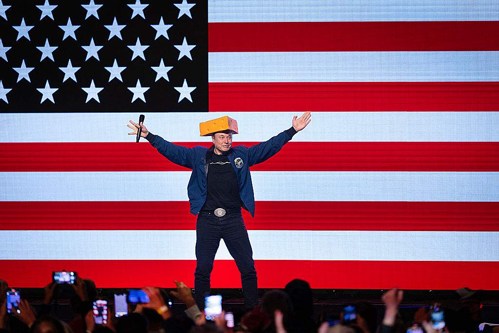 Billionaire businessman Elon Musk arrives for a town hall meeting wearing a cheesehead hat at the KI Convention Center on March 30, 2025 in Green Bay, Wisconsin.