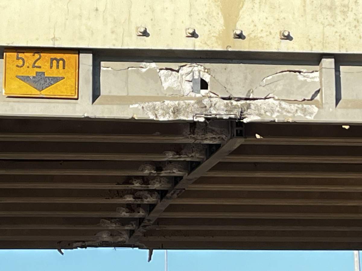 An overpass on Edmonton's eastern outskirts sustained damage when it was struck by a semi-truck late Monday night and drivers reported delays in the area as a result of closures on Tuesday morning.