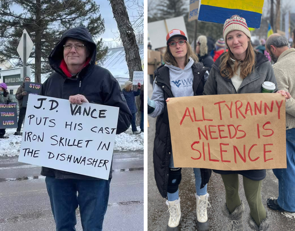 Protesters show their signs criticizing JD Vance.