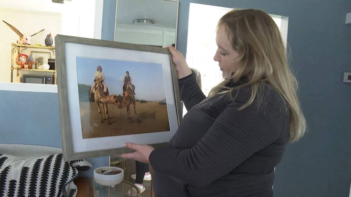 Emily King-Moore, seen holding a photo of her and long-time friend 34-year-old Minetta Norrie describes her as adventurous and full of life.