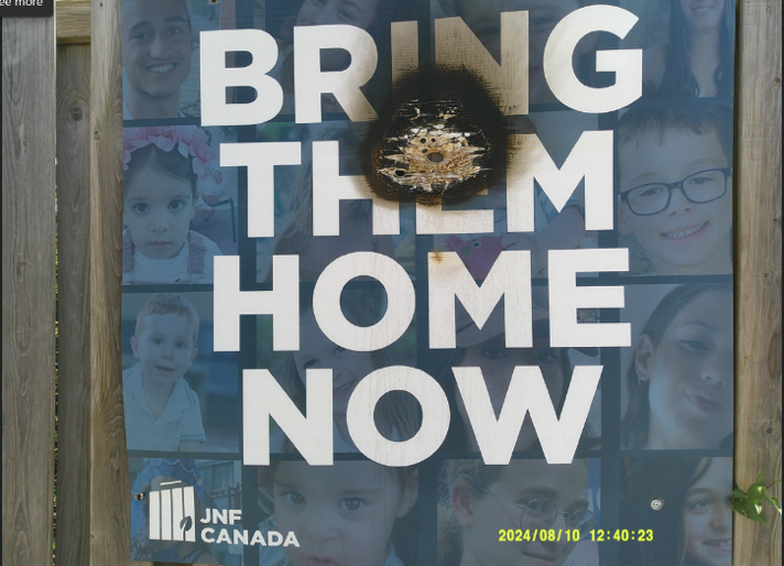 A sign outside Toronto’s Tiferet Israel Congregation showing photos of children held hostage by Hamas was allegedly torched by Amir Arvahi Azar on Aug. 3, 2024.