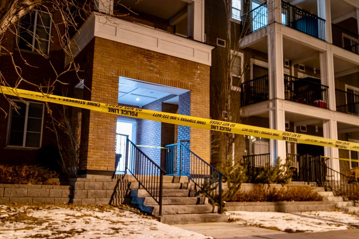 Police tape surrounds the front entrance of an apartment building in Legacy where the body of a man was discovered inside on Tuesday, March 11, 2025.