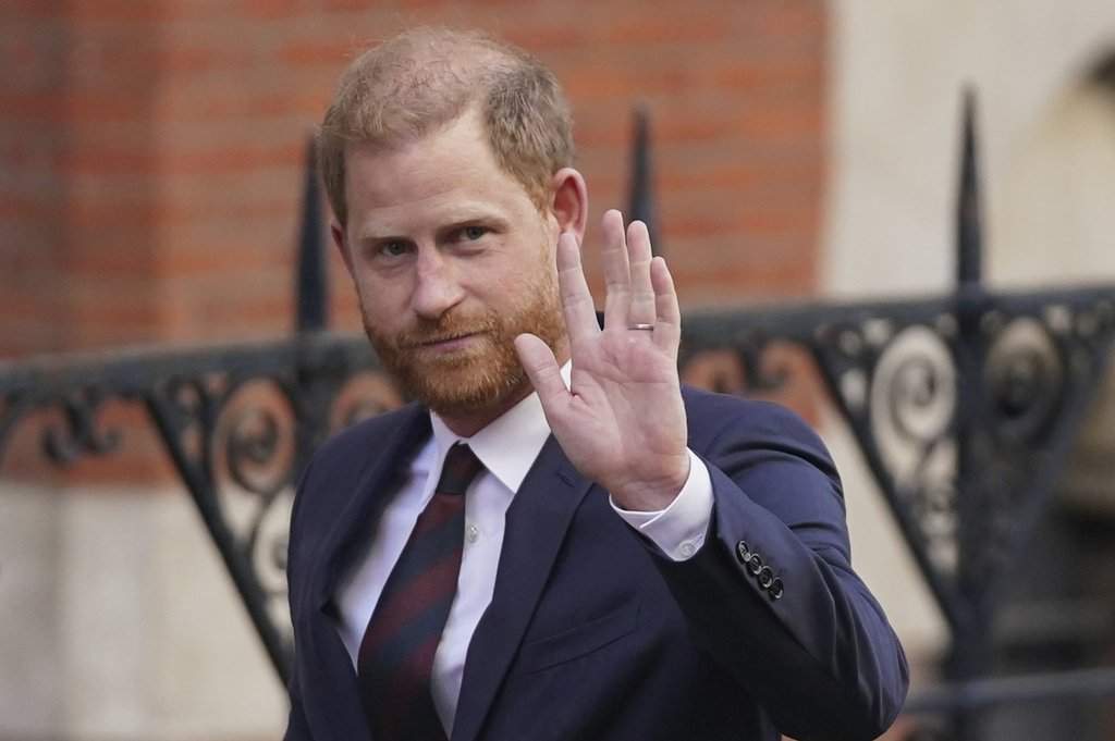 Prince Harry waves as he leaves the Royal Courts of Justice in London, Wednesday, April 9, 2025.