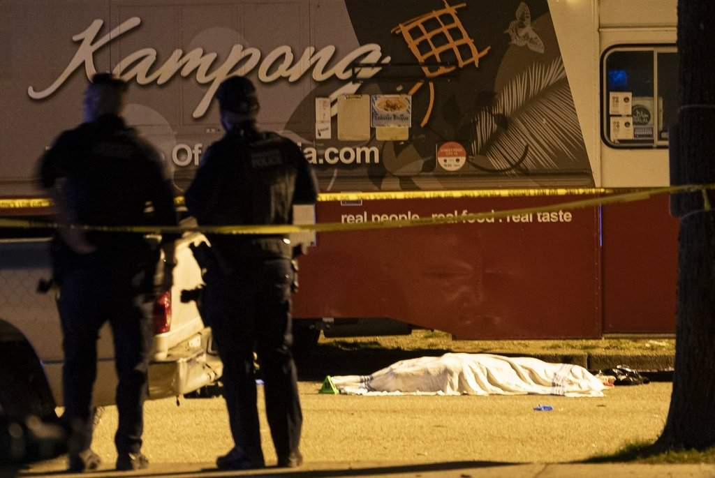 A victim lies near a food truck after a car drove into a crowd at the Lapu Lapu Festival in Vancouver on Saturday April 26, 2025. THE CANADIAN PRESS/Rich Lam
