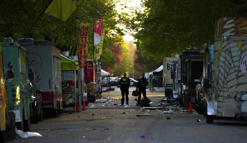 Members of the Vancouver Police forensics team examine the scene where a vehicle drove into a crowd at a Lapu Lapu Day street festival Saturday evening in Vancouver, Sunday, April 27, 2025. Shock and grief rippled through Canada's Filipino community on Sunday as members struggled to come to grips with an attack at a cultural street festival in Vancouver on Saturday that killed 11 people and injured dozens more. 