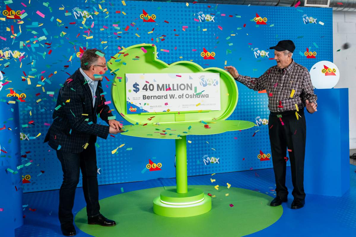 Bernard White, right, one of the latest winners of the Lotto Max jackpot from Feb. 21, 2025, draw.