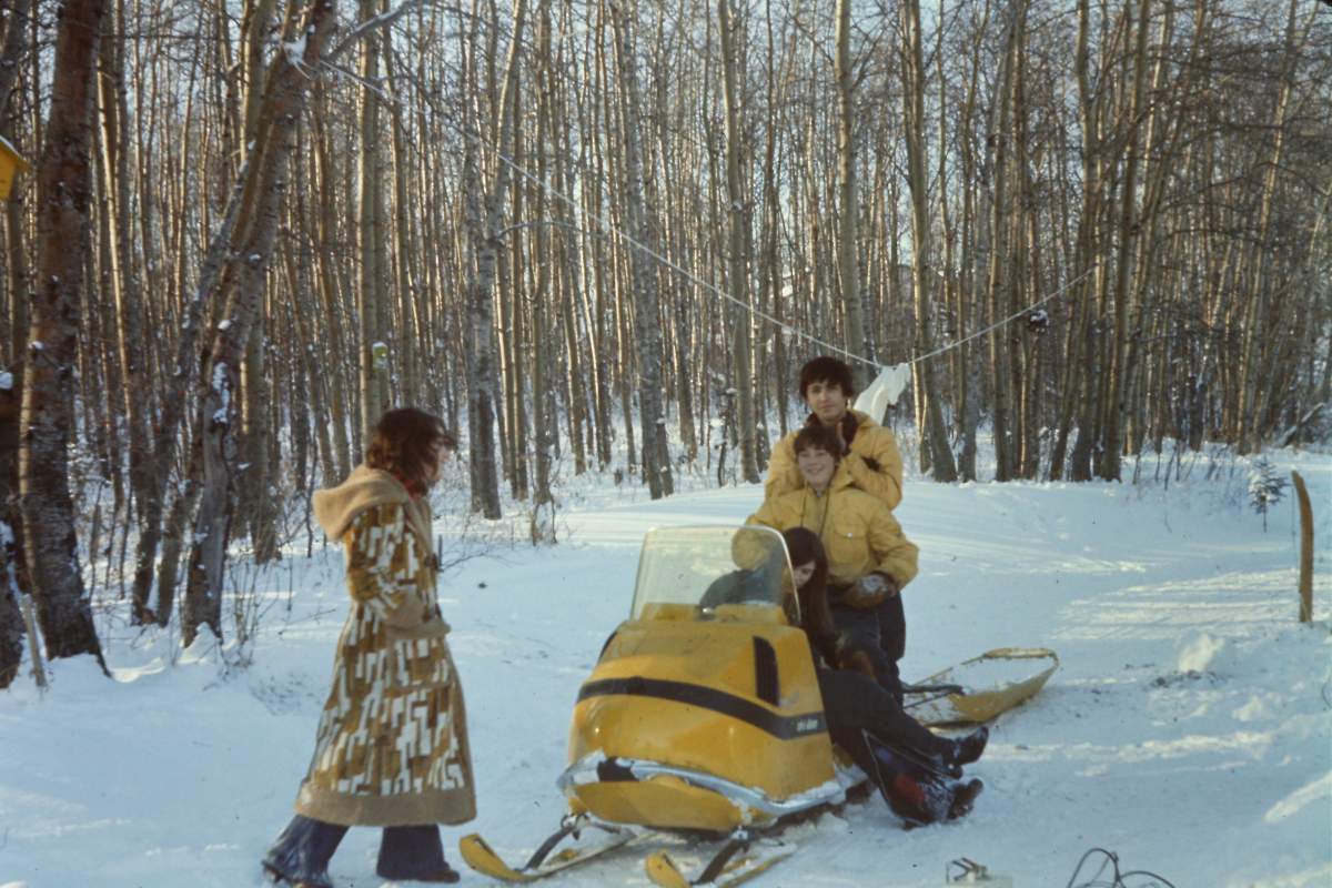 Photo of kids on a snowmobile.