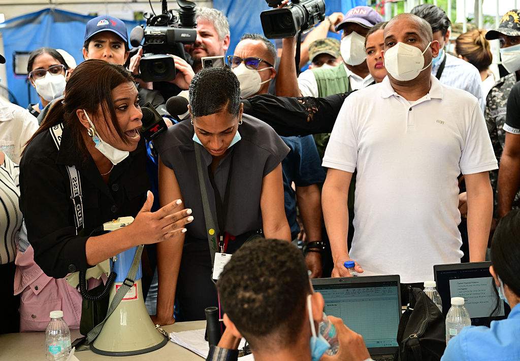 A woman argues with Forensic National Institute morgue employees for delays on information on their relatives after the Jet Set nightclub roof collapsed in Santo Domingo on April 11.