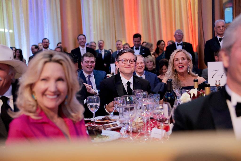 House Speaker Mike Johnson listens as President Donald Trump speaks during the National Republican Congressional Committee (NRCC) dinner at the National Building Museum on April 08, 2025 in Washington, DC. Trump spoke on a range of topics, including recent House special elections, changes his administration has made and the future of the Republican party.