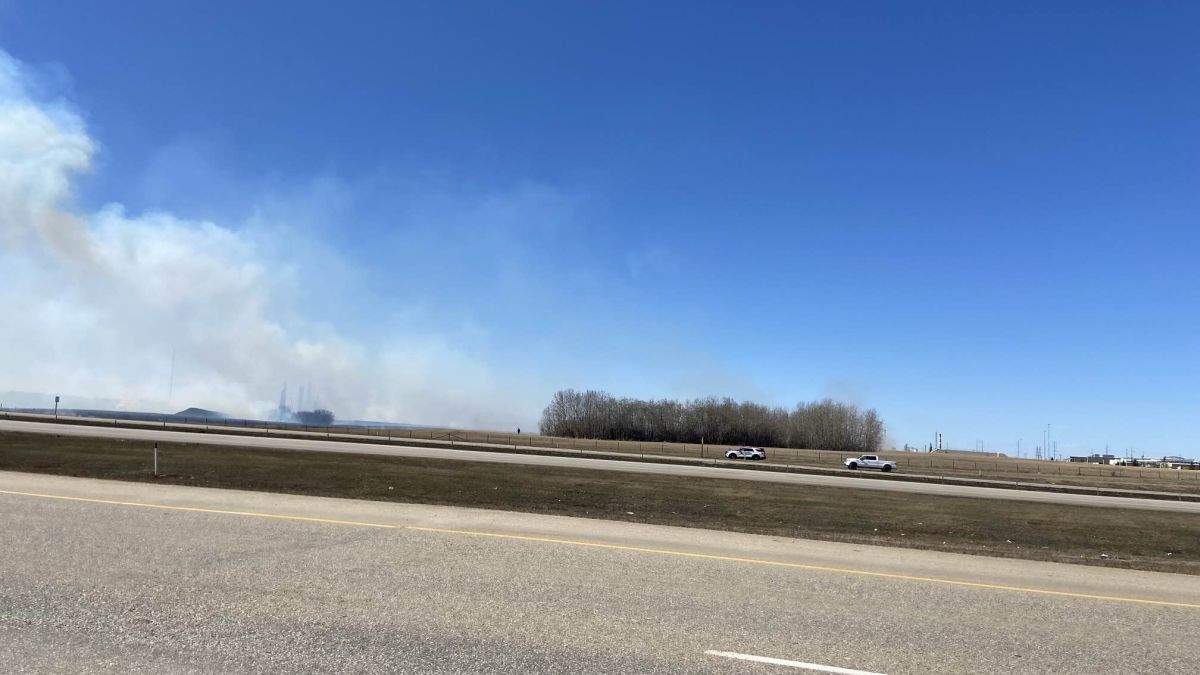 A grass fire burns near Anthony Henday Drive east of Edmonton on April 19, 2025.