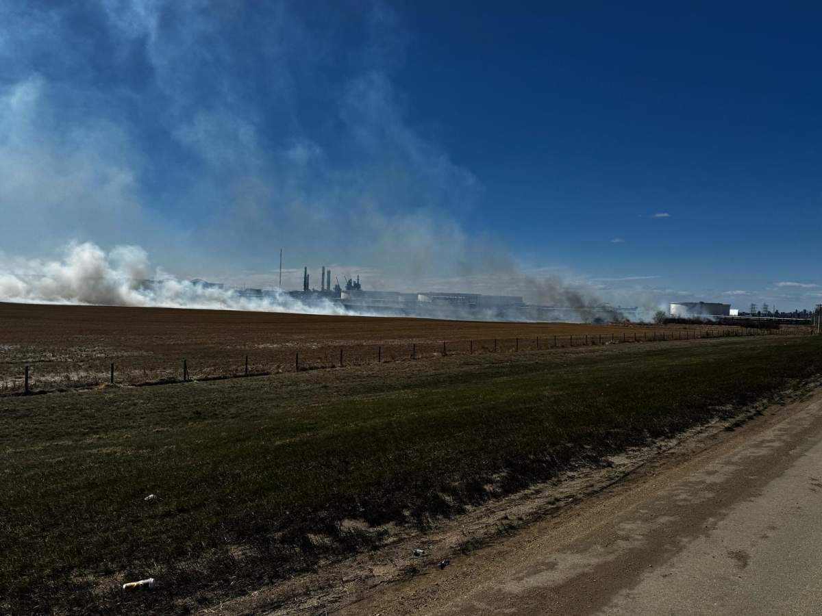 A grass fire burns near Anthony Henday Drive east of Edmonton on April 19, 2025.