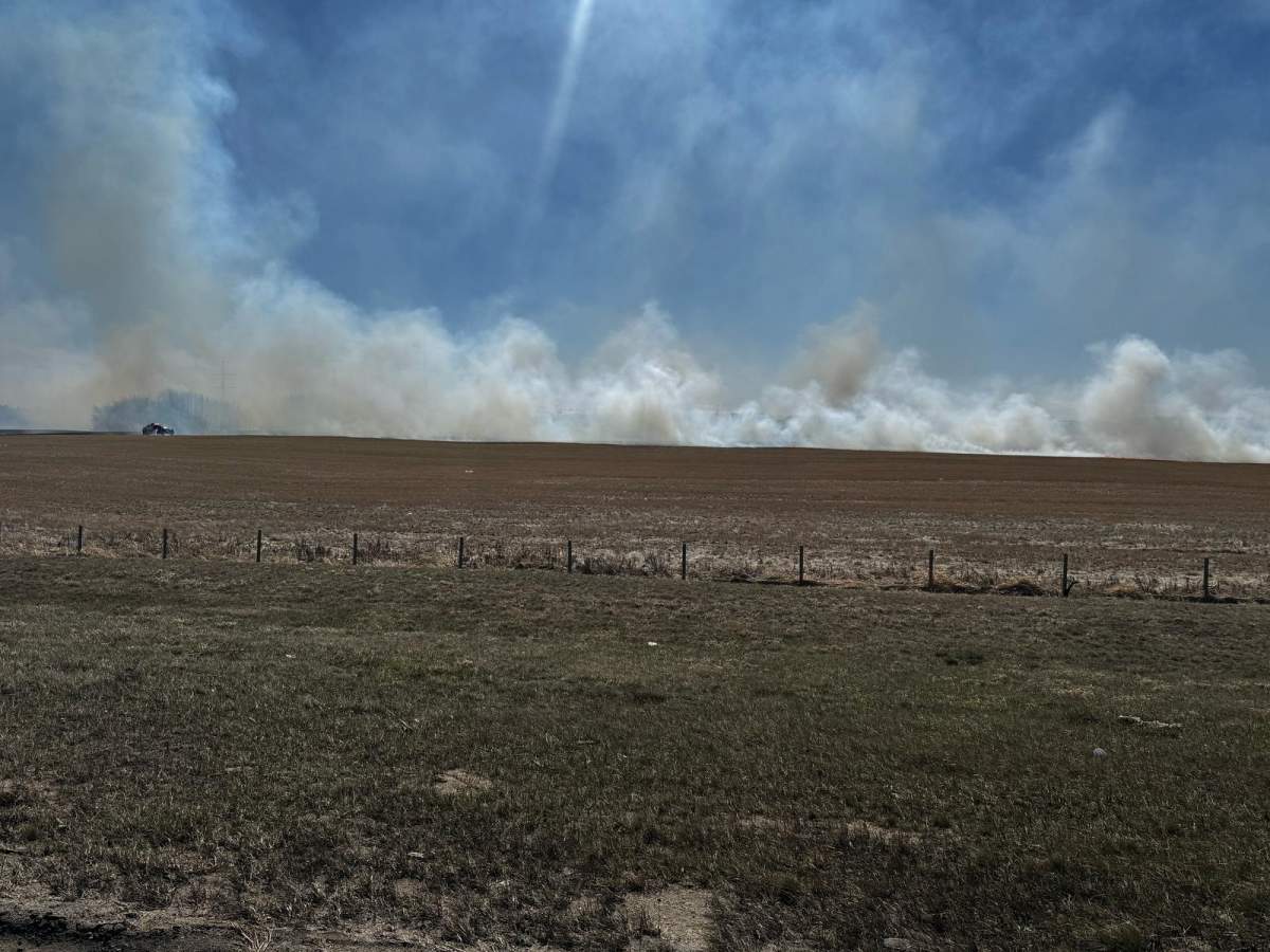 A grass fire burns near Anthony Henday Drive east of Edmonton on April 19, 2025.