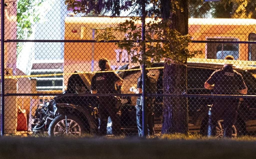 Vancouver police look over a black car believed to be involved in an incident where a vehicle drove into a crowd at the Lapu Lapu Festival in Vancouver on Saturday April 26, 2025.  THE CANADIAN PRESS/Rich Lam