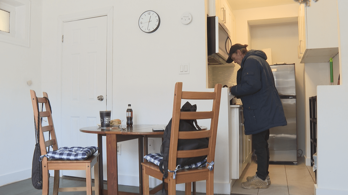 Brent Blake making himself a snack while exploring his new permanent housing.