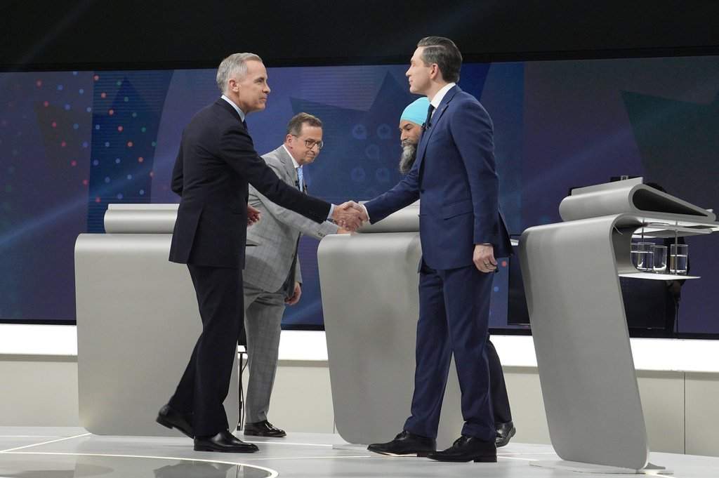 Liberal Leader Mark Carney, Conservative Leader Pierre Poilievre, Bloc Québécois Leader Yves-Francois Blanchet and New Democratic Party Leader Jagmeet Singh shake hands following the French-language federal leaders' debate, in Montreal, Wednesday, April 16, 2025.