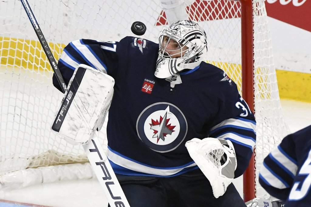Winnipeg Jets goaltender Connor Hellebuyck (37) makes a save on a St. Louis Blues shot during third period NHL playoff action in Winnipeg, Monday April 21, 2025. THE CANADIAN PRESS/Fred Greenslade.