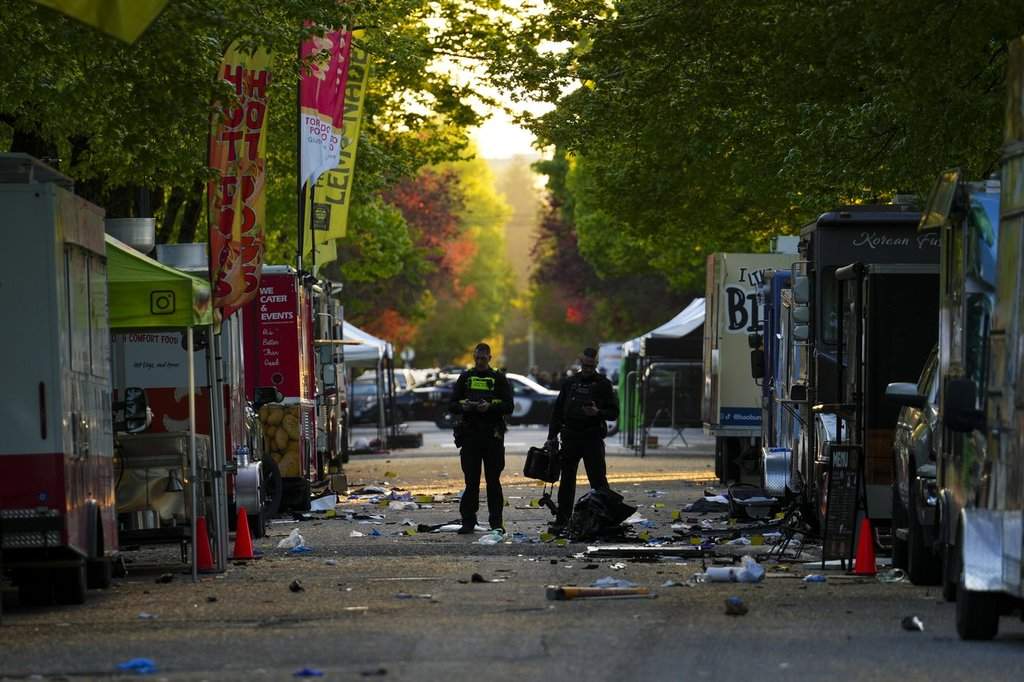 Members of the Vancouver Police forensics team examine the scene where a vehicle drove into a crowd at a Lapu Lapu Day street festival Saturday evening in Vancouver, Sunday, April 27, 2025. Shock and grief rippled through Canada's Filipino community on Sunday as members struggled to come to grips with an attack at a cultural street festival in Vancouver on Saturday that killed 11 people and injured dozens more.