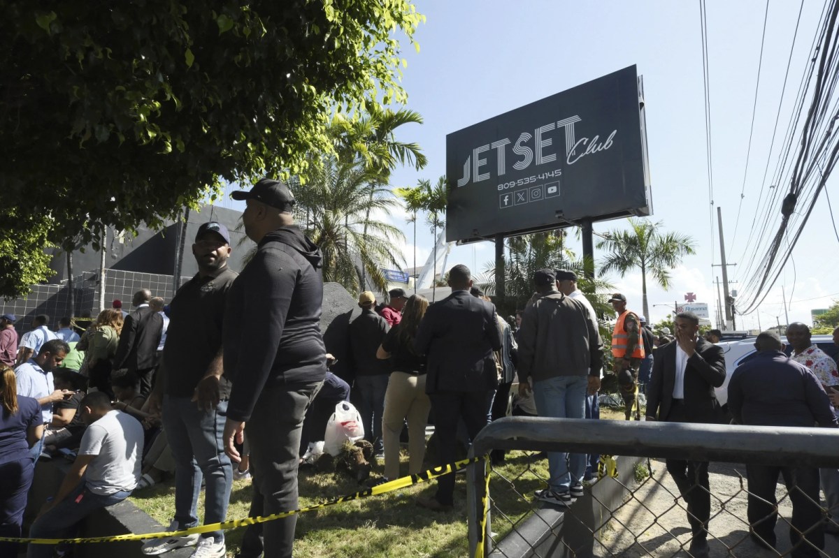 People gather outside the Jet Set nightclub after its roof collapsed during a merengue concert in Santo Domingo, Dominican Republic, Tuesday, April 8, 2025.