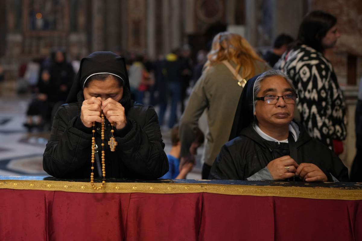 Nuns pray inside St. Peter’s Basilica where Pope Francis is lying in state, at the Vatican, Thursday, April 24, 2025. (AP Photo/Alessandra Tarantino)