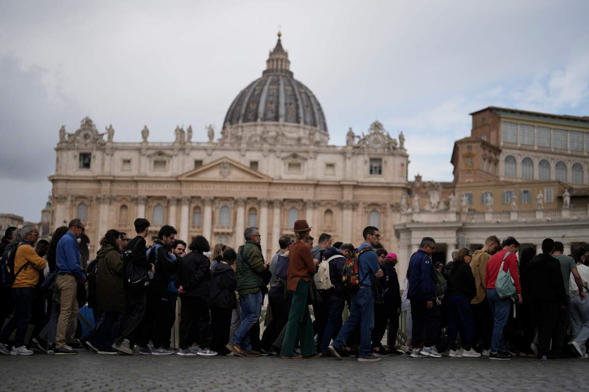 People wait in line to view Pope Francis lying in state inside St. Peter’s Basilica, at the Vatican, Thursday, April 24, 2025. (AP Photo/Markus Schreiber)