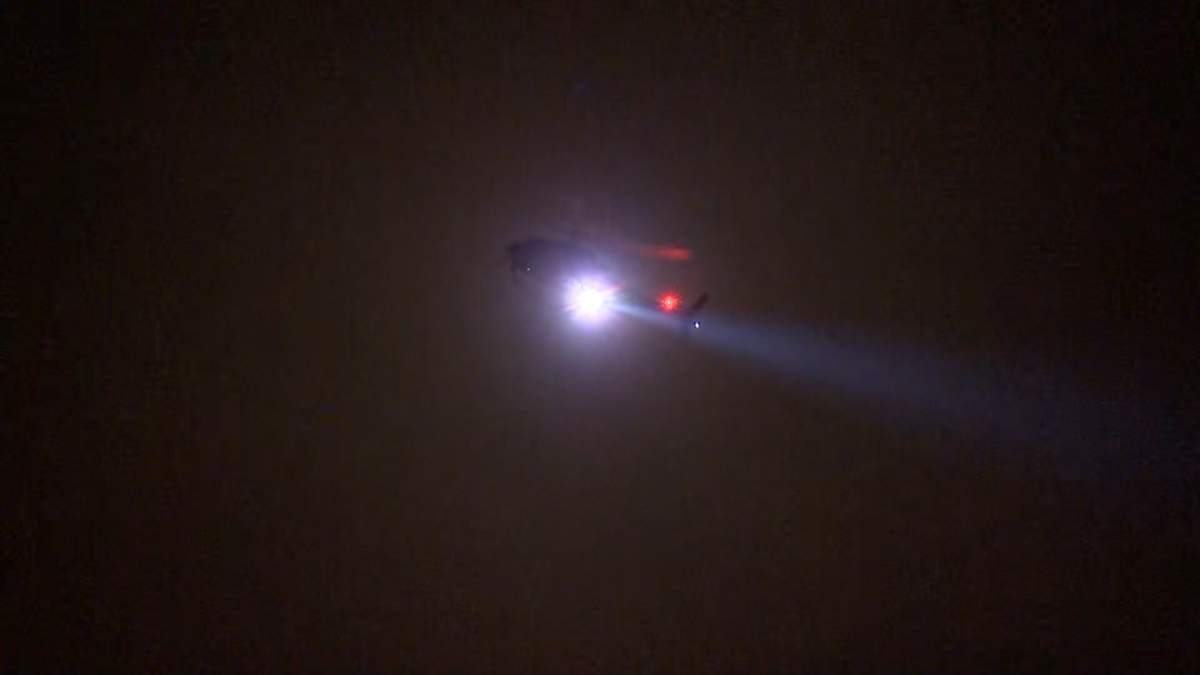 A Calgary police helicopter could be seen flying over the area and using it's powerful spotlight to light the area for investigators.