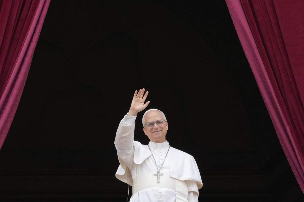 Pope Leo XIV appears on the central balcony of St. Peter's Basilica at the Vatican to bless the crowd below on May 11, 2025.