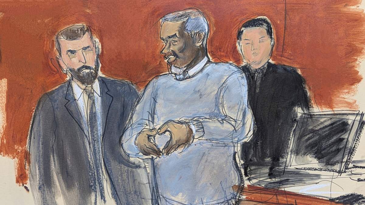 Sean Diddy Combs, center, motions a heart sign to his family in attendance as he is escorted out of lock-up by US Marshals, on the first day of trial, Monday, May 12, 2025, in New York.