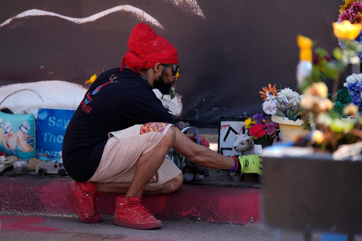 A person visits the spot of George Floyd’s murder at George Floyd Square on the five-year anniversary of Floyd’s death, Sunday, May 25, 2025, in Minneapolis. (AP Photo/Abbie Parr)