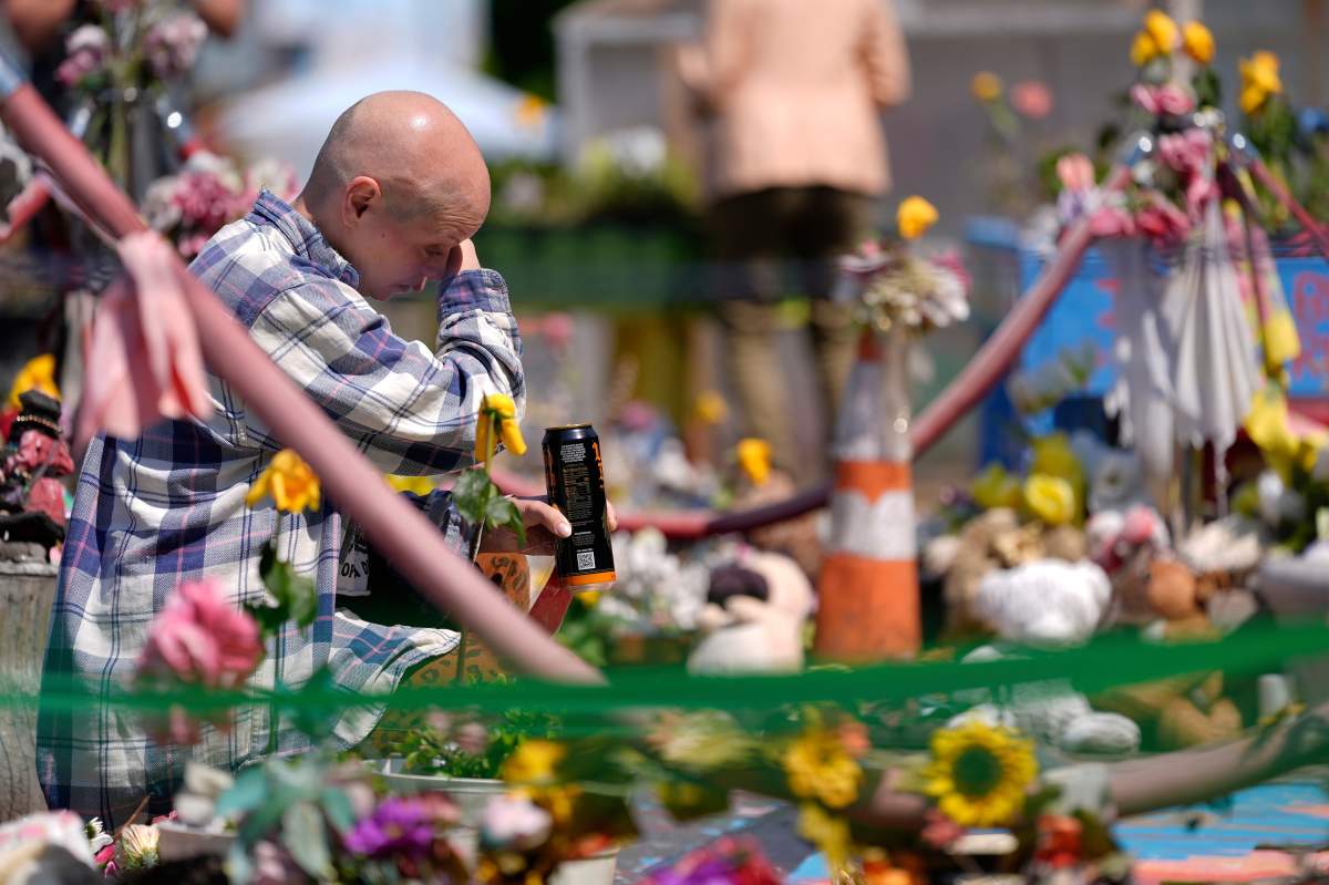 A person sits at George Floyd Square on the 5-year anniversary of Floyd’s death, Sunday, May 25, 2025, in Minneapolis. (AP Photo/Abbie Parr)