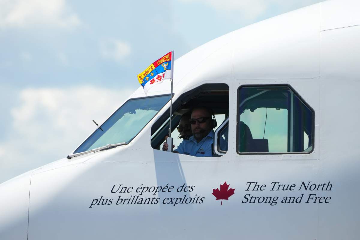 The standard of Charles III, King of Canada, flies out of the cockpit window as King Charles and Queen Camilla arrive at the Ottawa International Airport in Ottawa for a royal visit, on Monday, May 26, 2025. THE CANADIAN PRESS/Sean Kilpatrick