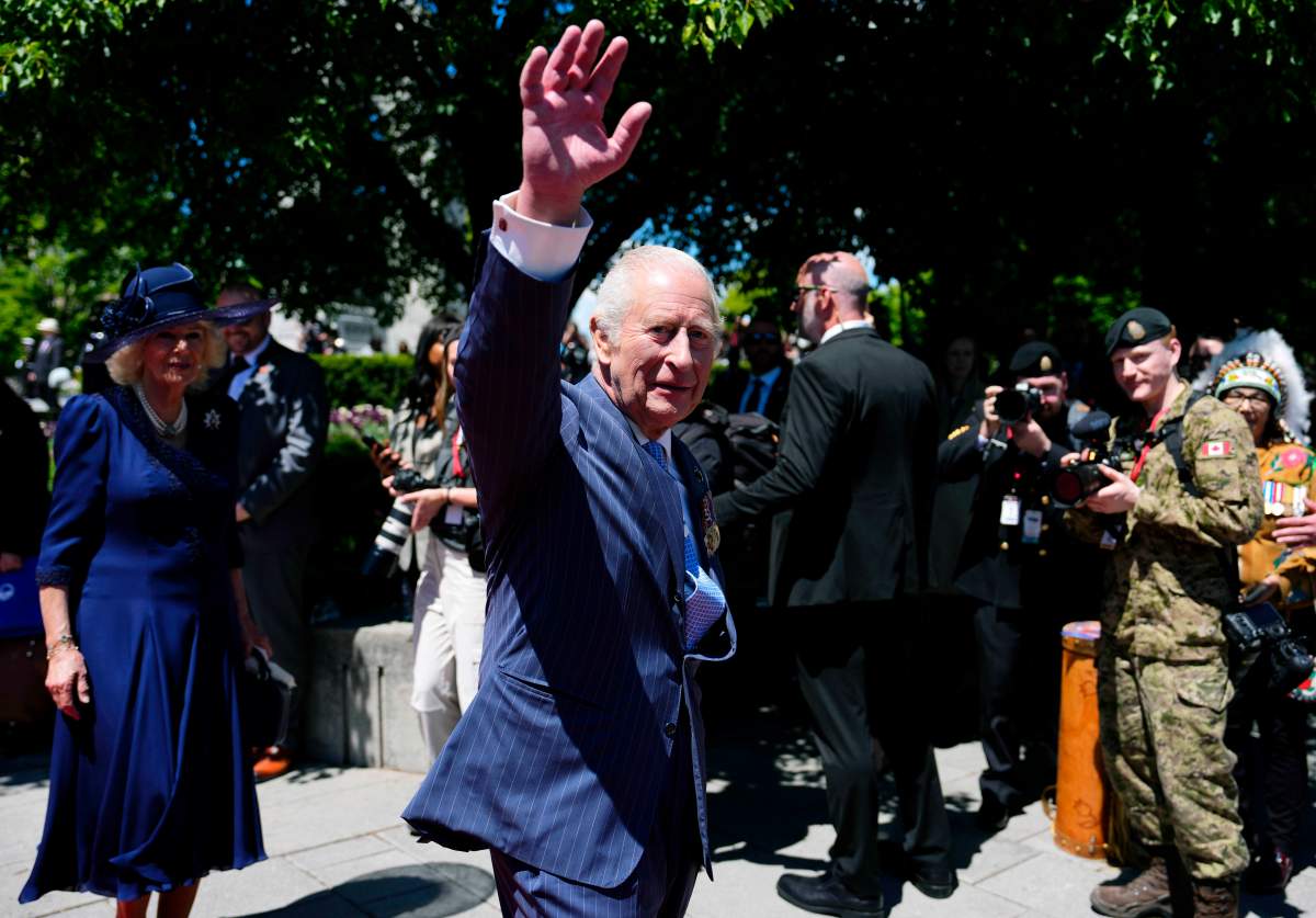 King Charles waves to the crowd as he and Queen Camilla depart after laying a wreath at the Tomb of the Unknown Soldier at the National War Memorial in Ottawa during a royal visit, on Tuesday, May 27, 2025. THE CANADIAN PRESS/Justin Tang