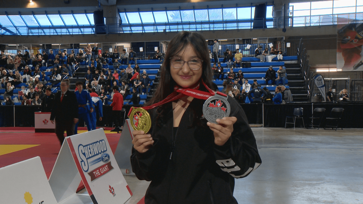 Emiliya Aliyeva shows off her gold and silver medals.