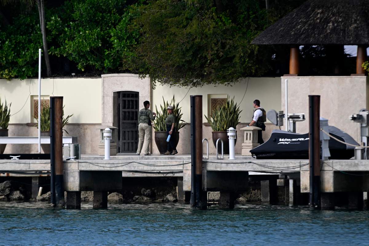 Police and Homeland Security officers are seen at the waterfront mansion of Sean Combs aka Diddy in Miami during a bi-coastal raid on March 25, 2024 in Miami Beach, Florida.
